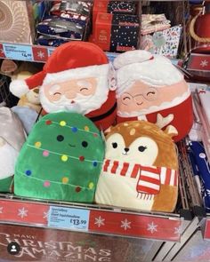 stuffed animals are on display for sale in a toy store's christmas decorations section