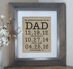 a framed burlap print with the date and birth year on it next to a vase filled with flowers