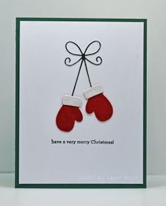 a christmas card with two red mittens on it