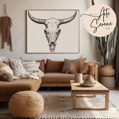 a living room with a couch, table and cow skull on the wall above it