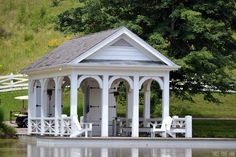 a white gazebo sitting on top of a lake