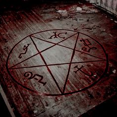 a pentagramus with the number twenty and nine pointed out in red ink on an old wooden floor