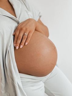 a pregnant woman with her hand on her belly