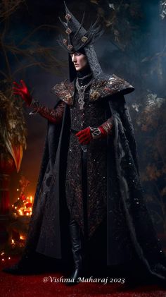 a man dressed in black and red is standing