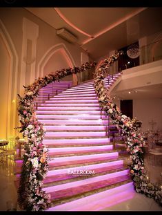 the stairs are decorated with flowers and greenery