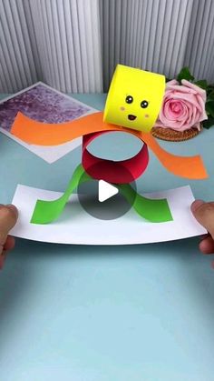 someone is making a paper sculpture with flowers