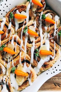 a white plate topped with waffles covered in cheese and carrots on top of a wooden table