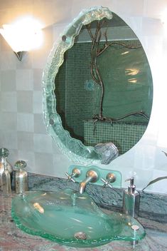 a bathroom sink sitting under a mirror next to a faucet