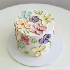 a white cake with colorful flowers on it