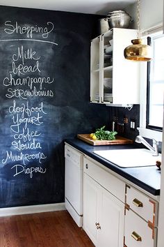 a chalkboard in the corner of a kitchen