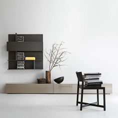 a modern living room with bookshelves and furniture in black and white color scheme