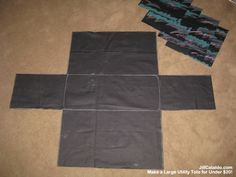 two pieces of black fabric laid out on the floor next to one piece of cloth