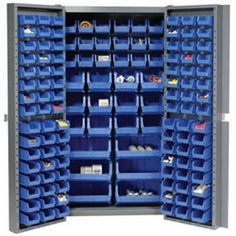 the storage cabinet is full of blue bins and plastic trays for various items