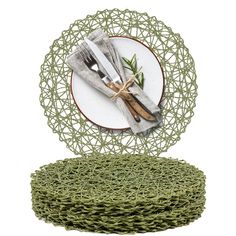 a plate with two forks and knifes on it next to a pile of green yarn