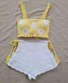 two pieces of crocheted clothing with flowers on the top and bottom, one is yellow