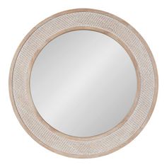 the round mirror is made from wood and has an intricate pattern on it's edge