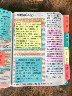 an open bible with colorful sticky notes on the pages and words written in different languages