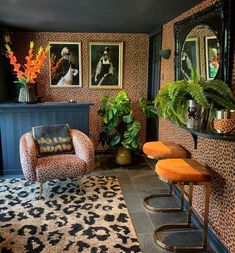 a living room with leopard print wallpaper and orange stools in front of the bar