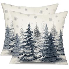 two pillows with snow covered trees on them