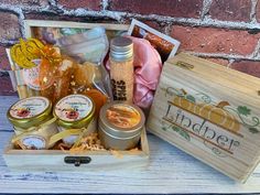 a wooden box filled with lots of different types of items next to a brick wall