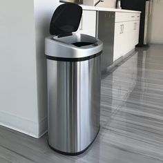 a stainless steel trash can next to a kitchen counter