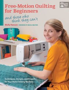 a woman sitting at a table with a sewing machine in front of her and the words free - motion quilting for beginners and those who think they can't