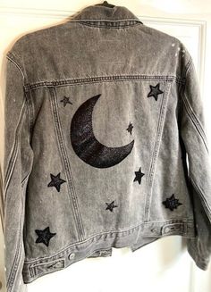 Bring the beauty of the moon and stars right to your closet! Hand sewn moon from black sparkling fabric on the back of this jacket hangs like it does in the night sky. Same fabric, hand sewn stars (13 to be exact; a lucky number) placed around jacket. Glitter lightly spread all over jacket to make any gloomy day glow or make a sunny day even brighter! Starry Outfit, Moon Jacket, Space Clothing, Sparkling Fabric, Star Jacket, Glitter Jacket, Diy Denim Jacket, Over Jacket, The Moon And Stars