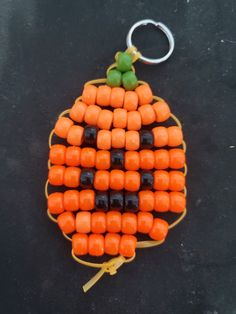 an orange and black beaded pumpkin key chain