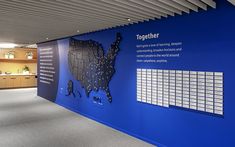 a large blue wall in an office with information about the united states and cities on it