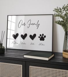 a dog's paw prints are displayed on a shelf next to a vase with flowers