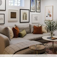 a living room filled with lots of furniture and pictures on the wall above it's coffee table