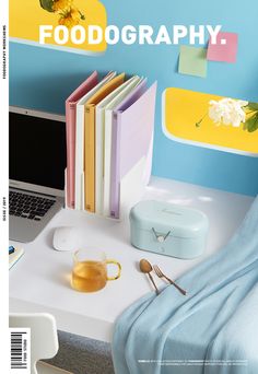 a magazine cover with an open laptop on a desk next to some books and other items