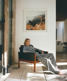 a woman sitting in a chair with her legs crossed