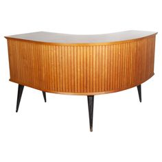 an oval shaped wooden cabinet with black legs