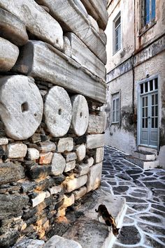 a dog is standing next to a stone wall