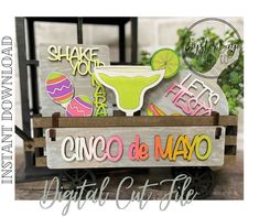 a wooden sign that says cinco de mayo on it and is decorated with neon colors