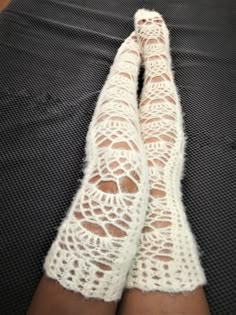 the legs of a woman wearing white lacy socks