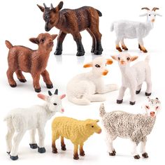 a group of farm animals sitting next to each other on top of a white surface