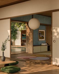 the interior of a house with an open door and round rugs on the floor