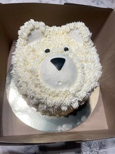 there is a cake in the shape of a polar bear with white frosting on it