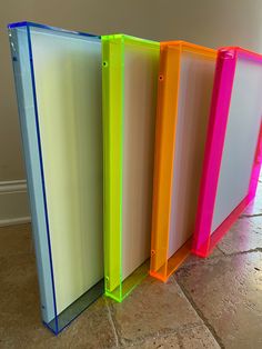 four different colored file folders sitting on the floor