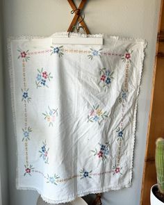 a white towel hanging on the wall next to a cactus