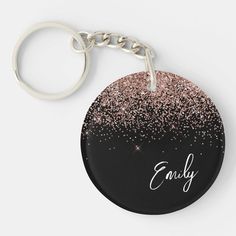 a black and pink keychain with the word enjoy on it's front