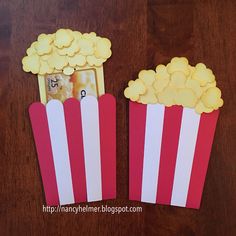 two red and white striped paper popcorn boxes