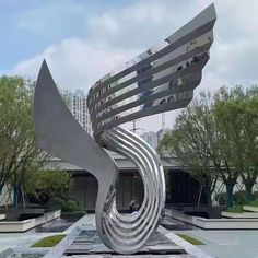 a large metal sculpture sitting in the middle of a park