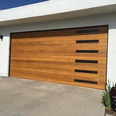 a white house with a wooden garage door