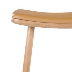 a close up of a wooden chair with a tan leather seat cover on it's back