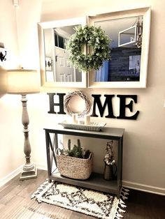 a living room with a lamp and some pictures on the wall next to a table