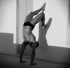 a man is doing a handstand on the floor