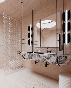 a bathroom with a marble sink and mirror on the wall next to a round light fixture